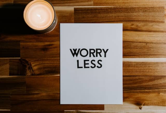 A sheet of paper that says worry less written on it