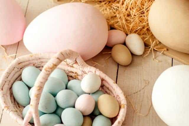 basket full of muted tone coloured easter eggs inside a room
