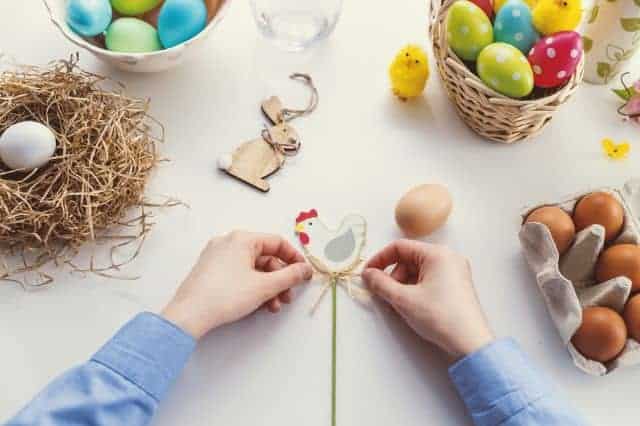 hands tying a bow on an easter egg