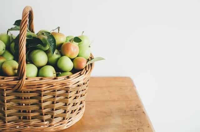 netted basket full of apples
