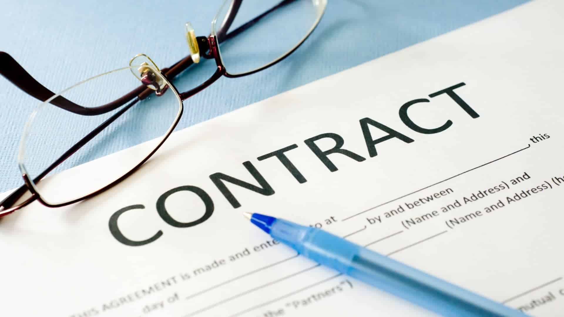 contract on table with pen and eye glass