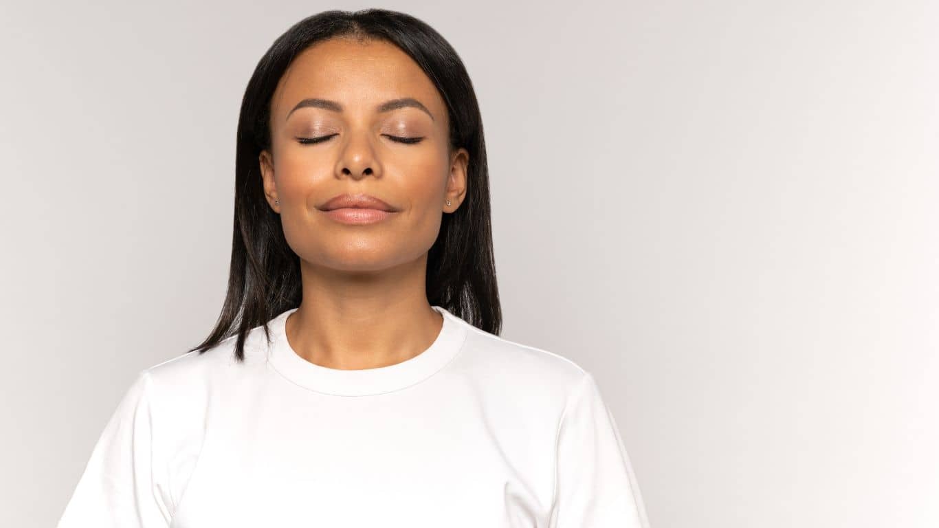 female closing her eyes and manifesting positive affirmations