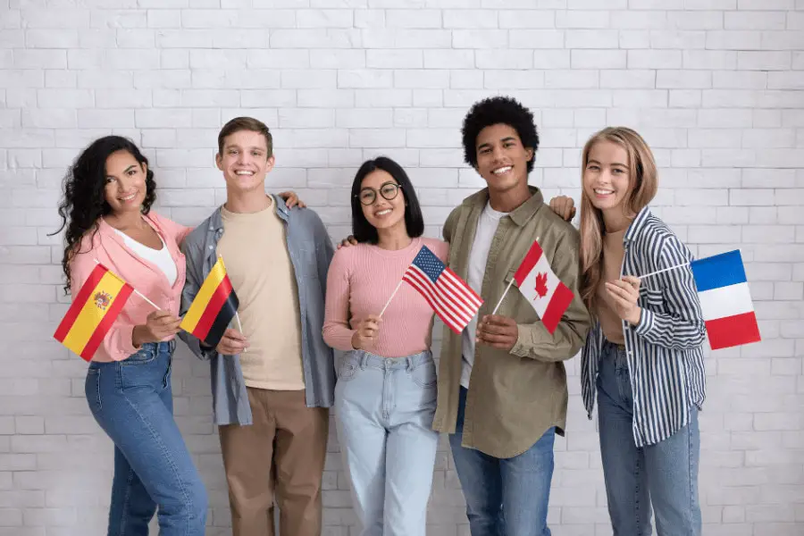 group of students standing and holding flags of different countries