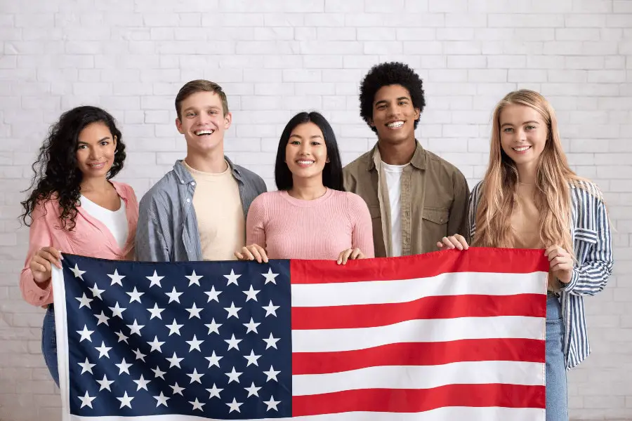 group of students holding an american flag