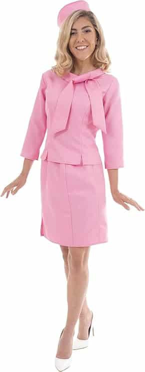 Image of a woman wearing a vintage-style pink skirt suit with a matching bow-tie top and pillbox hat, paired with white heels. This elegant retro outfit is ideal for **Barbie Halloween Costumes for Adults**, capturing a classic and sophisticated Barbie look perfect for themed parties or Halloween celebrations.