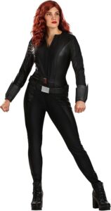 Image of a woman dressed in a sleek black jumpsuit with a utility belt, wrist cuffs, and wavy red hair. This fierce and stylish outfit is perfect for **halloween costumes red hair**, ideal for portraying a strong and action-ready hero character.