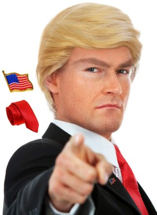 Here’s the alt text with your keyword included naturally:
Man wearing a blonde wig, red tie, and suit jacket with an American flag pin, pointing forward confidently. This humorous political-themed outfit is one of the standout halloween costumes for guys, great for parties or parody events.