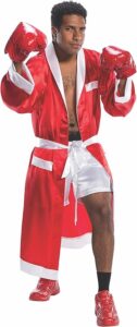 Man wearing a red satin boxing robe with white trim, matching red boxing gloves and shoes, and white boxing shorts tied with a sash. This bold, athletic ensemble channels a classic fighter vibe, making it a knockout choice for Halloween costumes for guys.