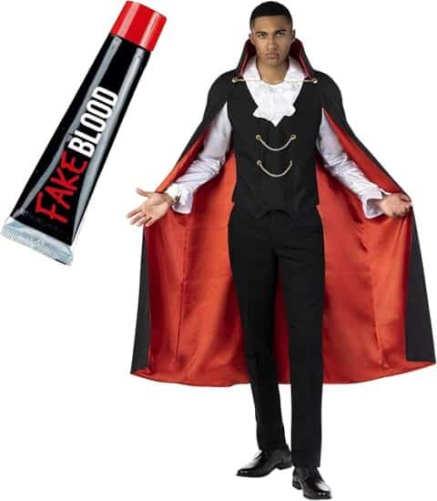 A man dressed in a classic vampire costume with a black and red-lined cape, ruffled white shirt, black vest with gold chain accents, and black pants, paired with a tube of fake blood. A spooky and stylish pick for traditional Halloween costumes for guys.