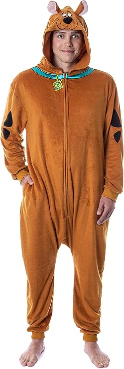 Man wearing a cozy Scooby-Doo onesie featuring a brown plush fabric, black spots on the arms, a teal collar with a yellow SD tag, and an attached hood with Scooby's face and ears. This playful and comfortable design is a great pick for Halloween costumes for guys who want something fun and laid-back.