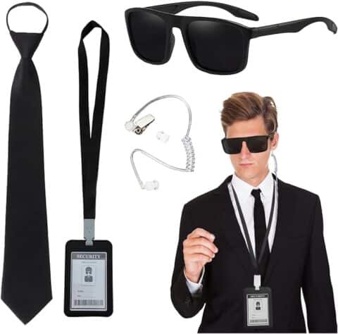 Secret agent or bodyguard costume set featuring a black tie, dark sunglasses, earpiece, and security badge worn with a black suit. This simple yet slick setup is a go-to for Halloween costumes for guys looking for a cool, undercover vibe.